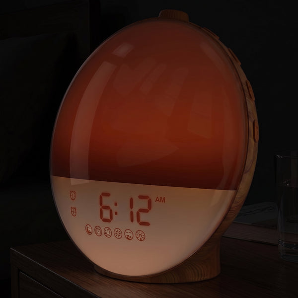 Sunrise clock glowing a dim ember in a dark bedroom thirty minutes before the alarm